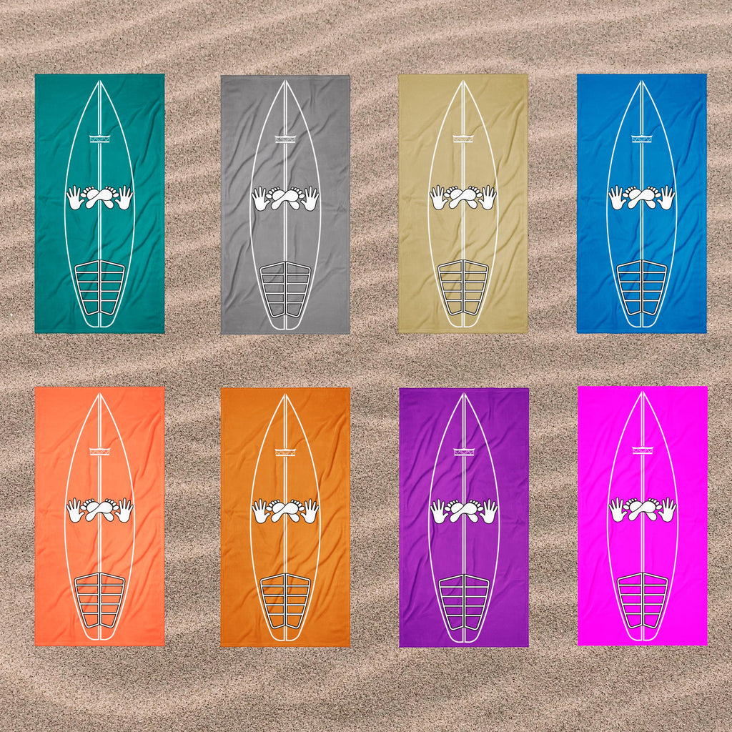 AI generated image of Eight beach towels in different colours are arranged in a 2x4 grid on a sandy background. Each towel features a white surfboard graphic with a surf stance guide