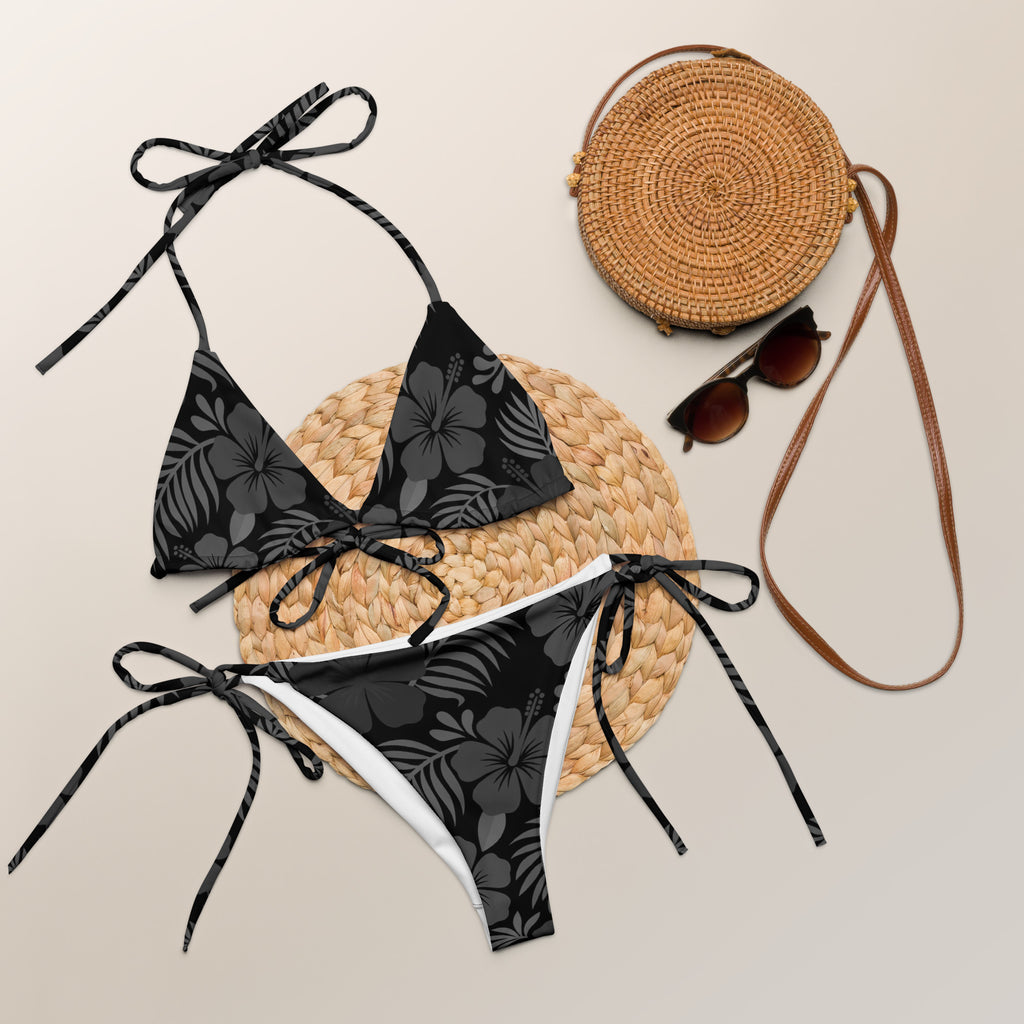 AI generated image of a Black Hibiscus pattern recycled string bikini Product shot with accessories