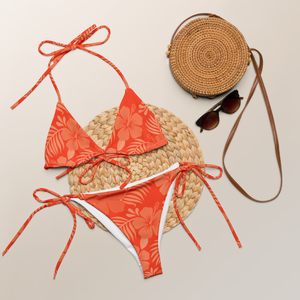 AI generated image of a Coral Hibiscus pattern recycled string bikini Product shot with accessories