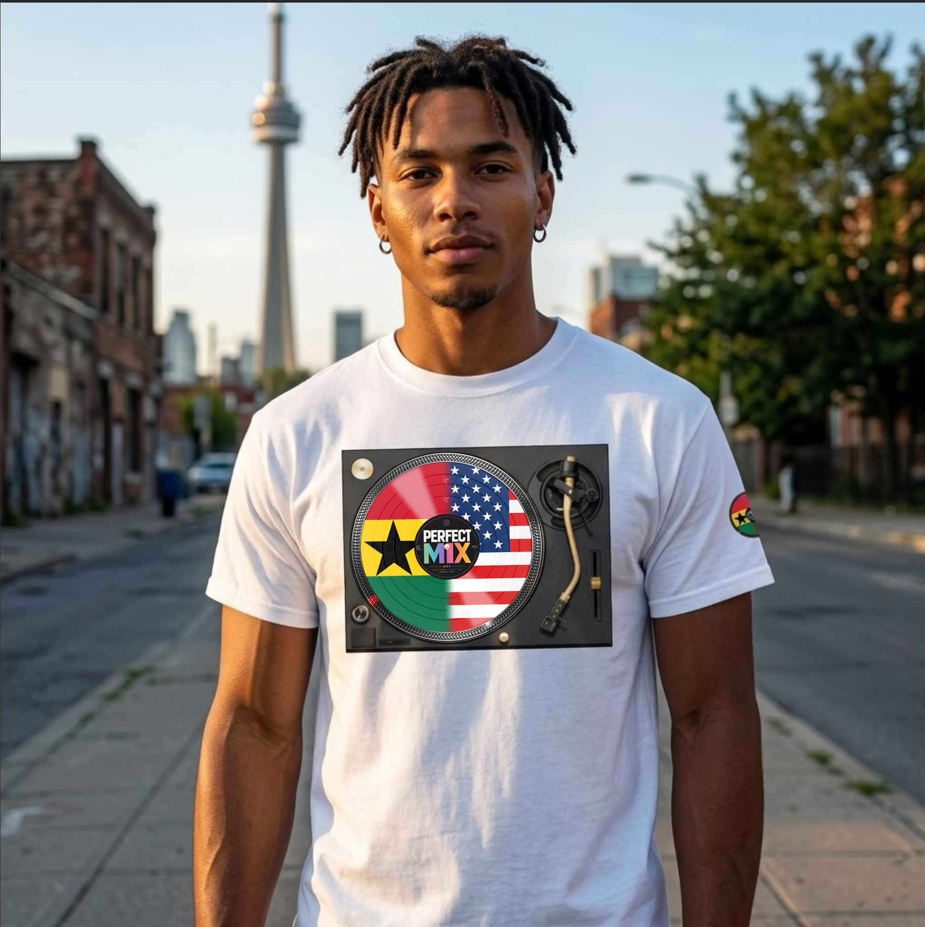 AI generated image of a  man wearing a white graphic t-shirt with a 'PERFECT MIX' turntable design featuring the Ghanaian and American flags, standing on a city street with the CN Tower in the background.