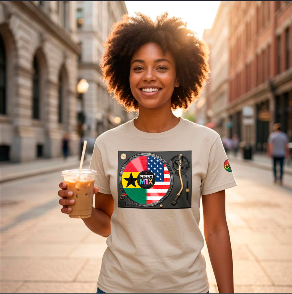 AI generated image of a  smiling woman with an afro stands on a city street at sunset, holding an iced coffee and wearing a beige graphic T-shirt. The shirt features a circular design with the words 'PERFECT MIX' with the  Ghanaian and American flags