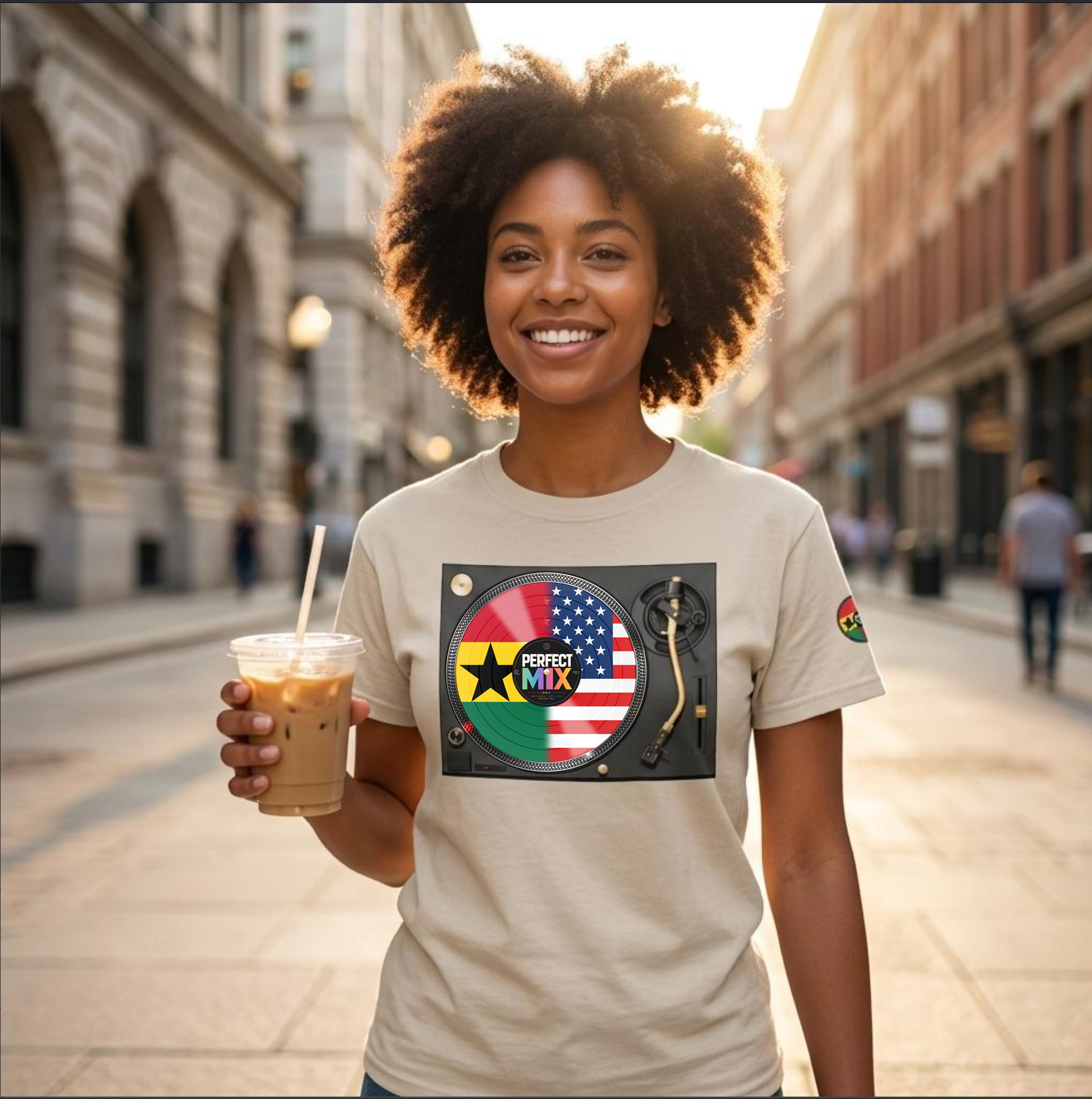 AI generated image of a  smiling woman with an afro stands on a city street at sunset, holding an iced coffee and wearing a beige graphic T-shirt. The shirt features a circular design with the words 'PERFECT MIX' with the  Ghanaian and American flags