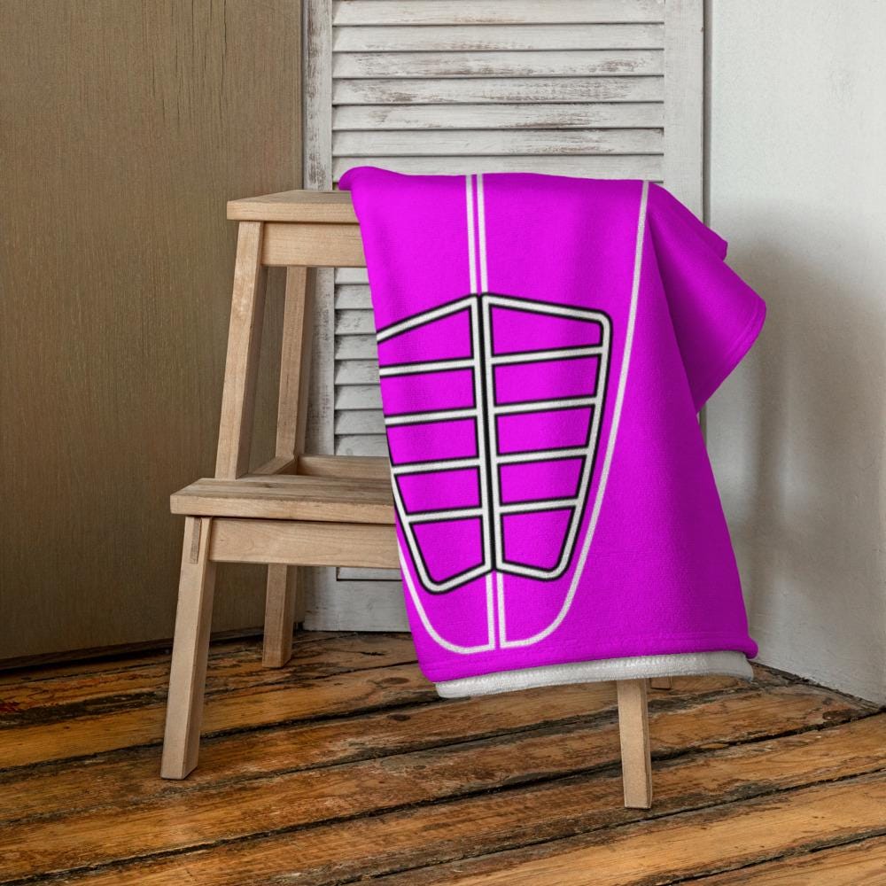 AI generated image of a Hot Pink Surf Pop-Up Training Mat – Oversized Quick-Dry Beach Towel with Stance Placement Guide on chair
