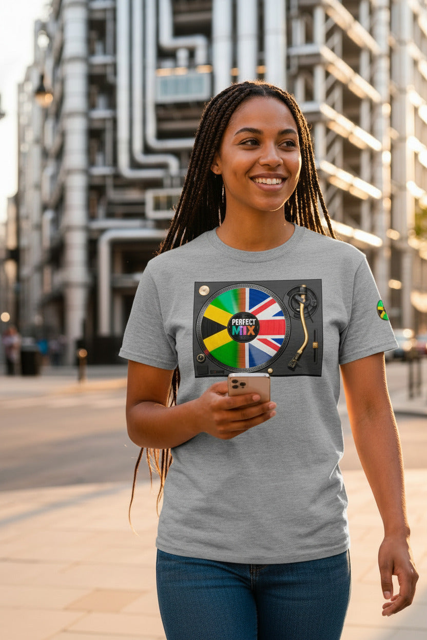 AI generated image of a woman standing in front of the Lloyds building in London at sunset, wearing a light grey t-shirt with a colourful graphic print featuring a turntable and the words 'PERFECT MIX' combined with the Jamaican and Union Jack flags