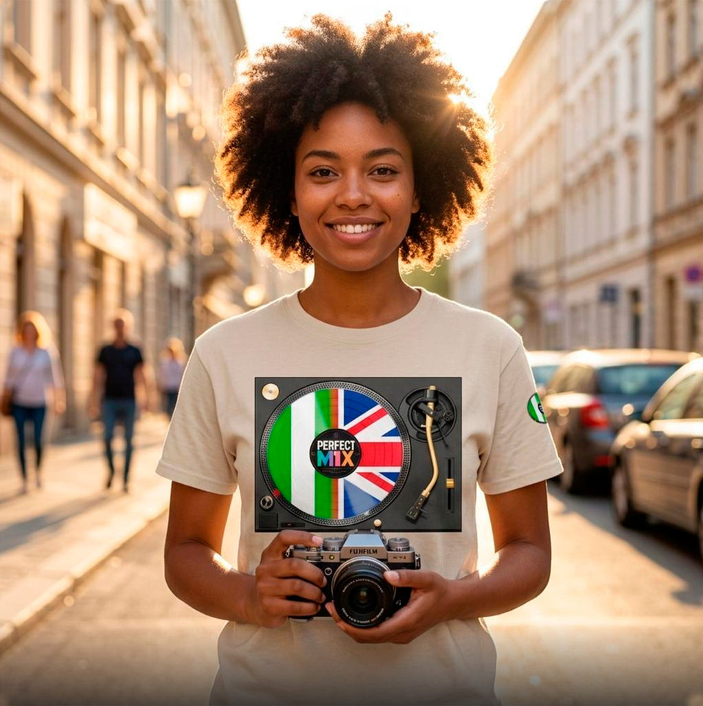 AI generated image of a smiling woman with an afro stands on a sunlit city street holding a camera, wearing a light beige T-shirt. The print shows a vinyl record design with the words 'PERFECT MIX' and and the Nigerian and British flags.