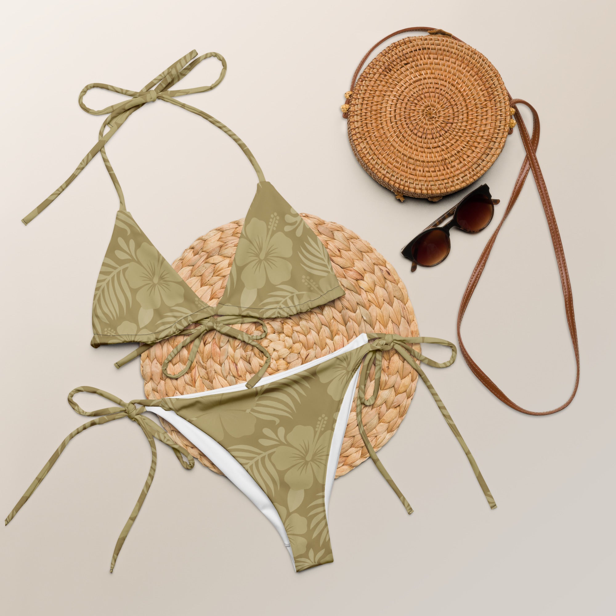AI generated image of a Sand Hibiscus pattern recycled string bikini Product shot with accessories