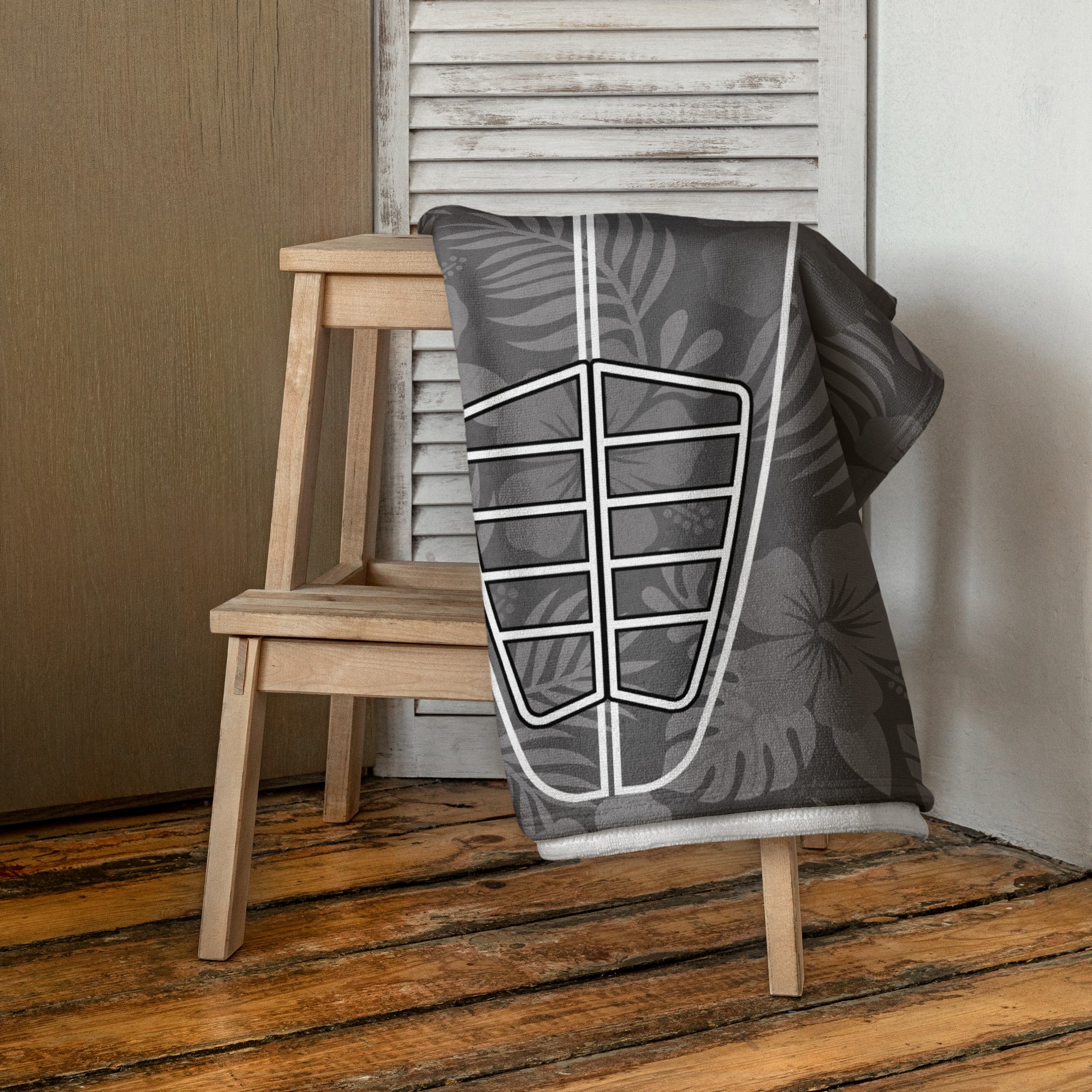 AI generated image of a Silver Grey Hibiscus Surf Pop-Up Training Mat – Oversized Quick-Dry Beach Towel with Stance Placement Guide on chair