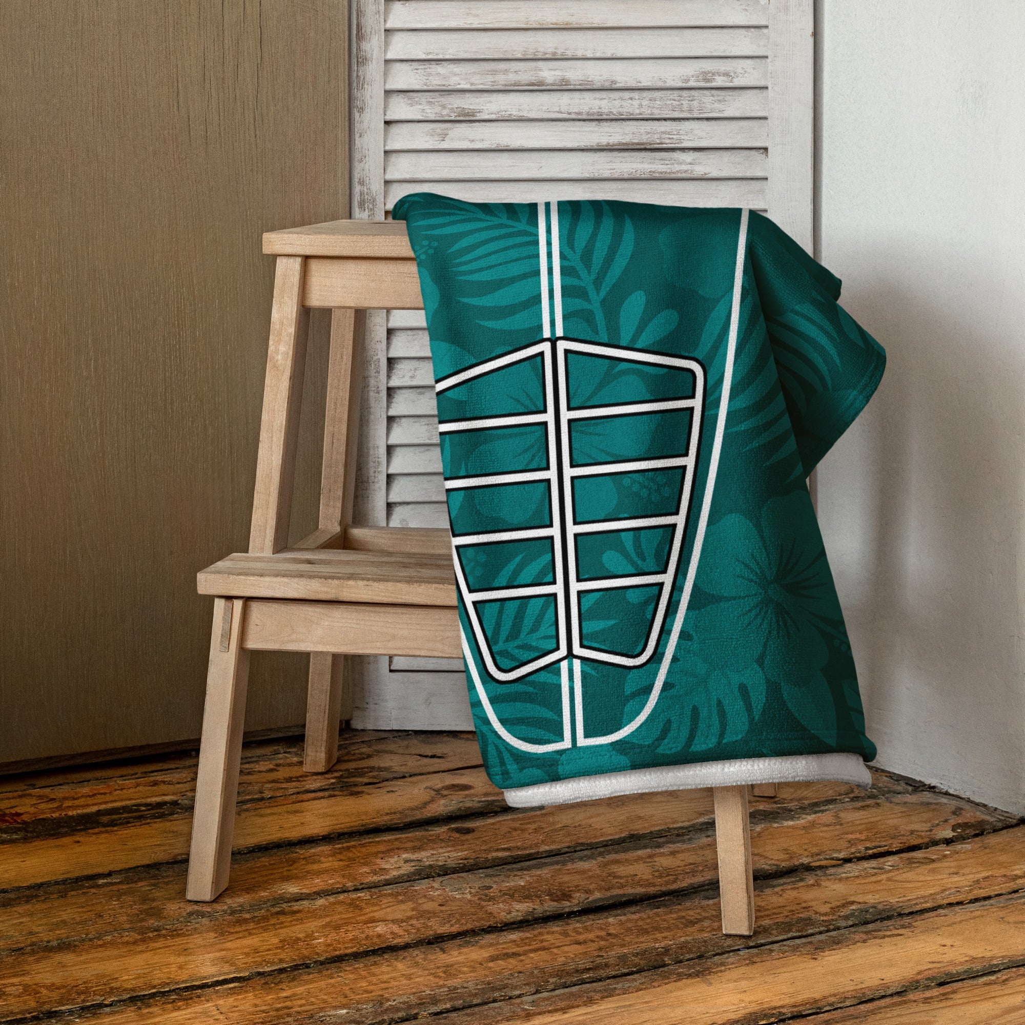 AI generated image of a Teal Hibiscus Surf Pop-Up Training Mat – Oversized Quick-Dry Beach Towel with Stance Placement Guide on chair