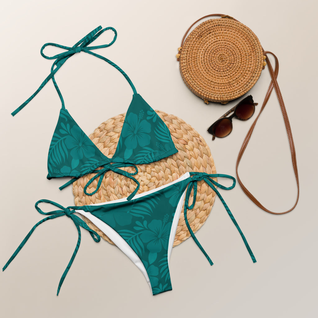 AI generated image of a Teal Hibiscus pattern recycled string bikini Product shot with accessories