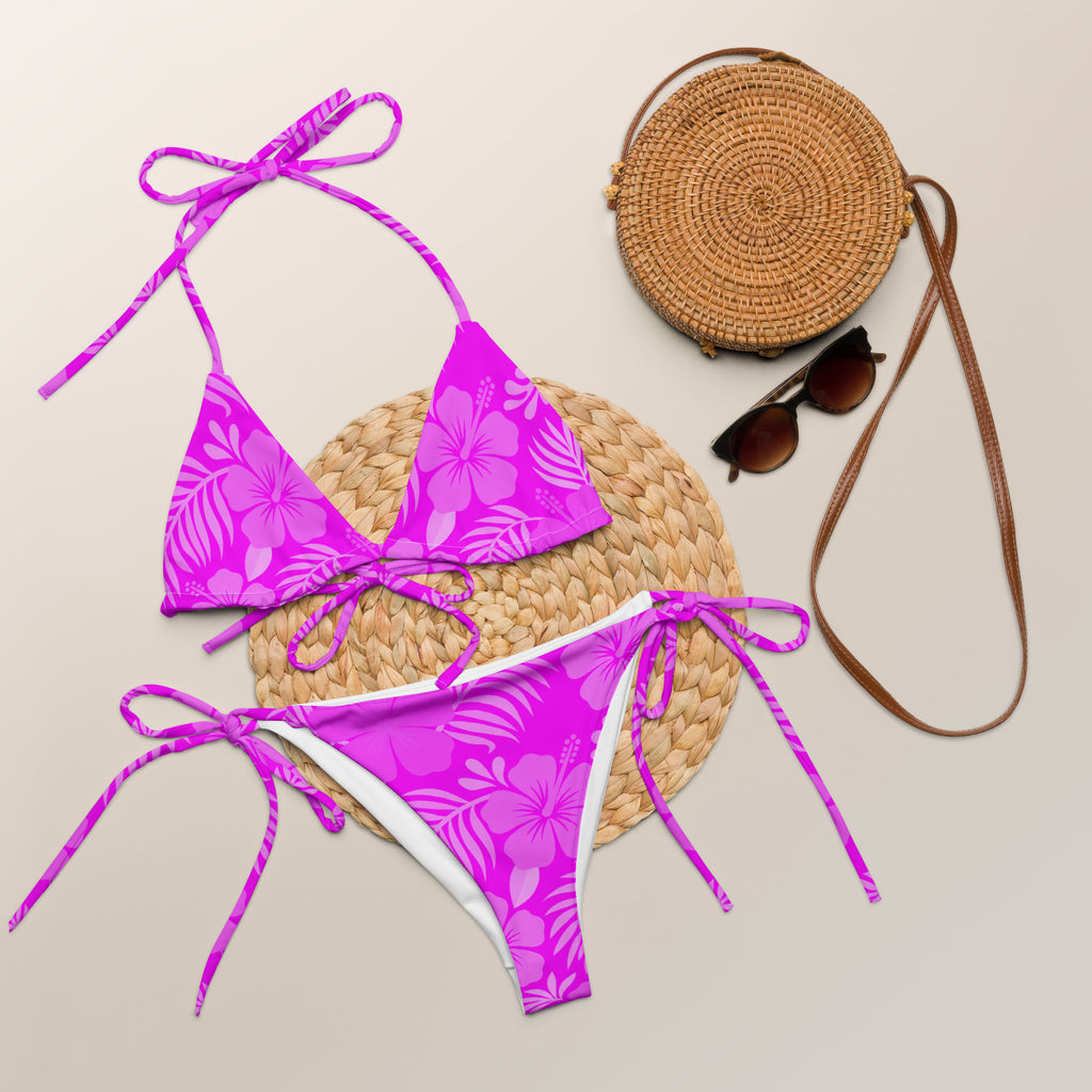 AI generated image of a pink Hibiscus pattern recycled string bikini Product shot with accessories