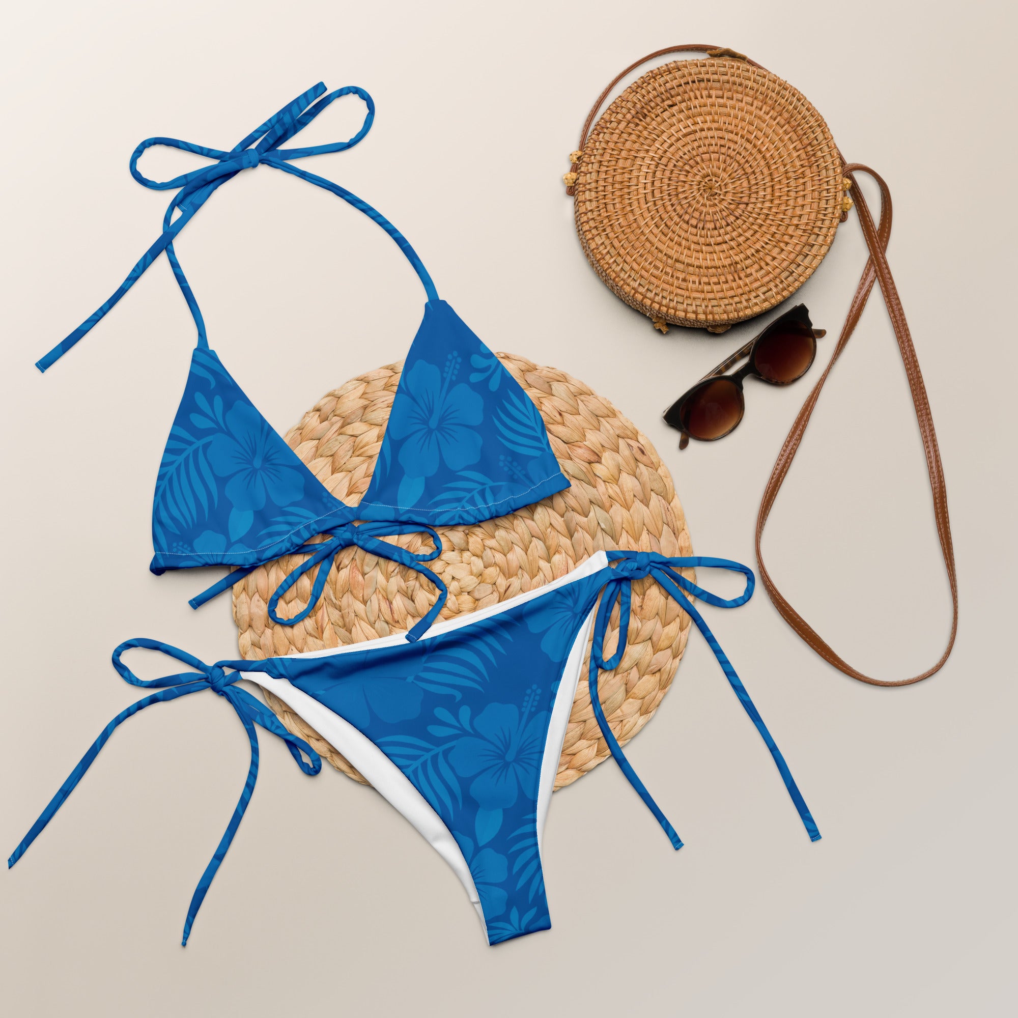 AI generated image of an Ocean Blue Hibiscus pattern recycled string bikini Product shot with accessories