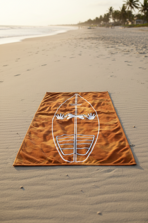 Clay Sci-Fi Camo Surf Pop-Up Training Mat – Oversized Quick-Dry Beach Towel with Stance Placement Guide lies on sandy beach near the shoreline, with palm trees and ocean visible in the background.