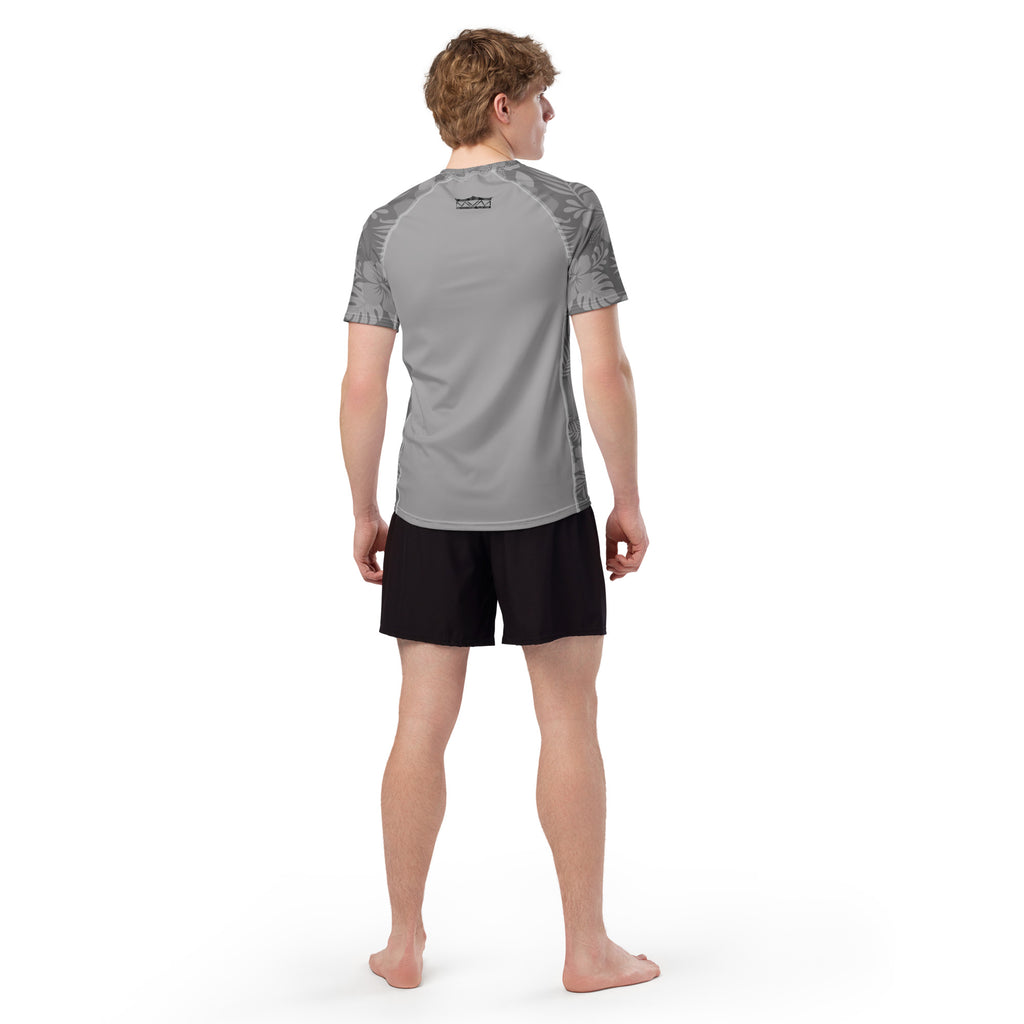 Majestic Vision Grey Hibiscus recycled rash vest with UPF 50+ protection, moisture-wicking performance fabric and bold surf-inspired artwork. Recycled Short Sleeved Rash Guard from behind Product mockup studio style