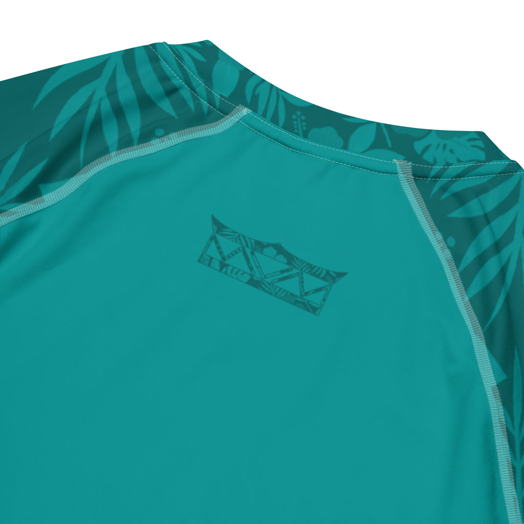 Majestic Vision Teal Hibiscus recycled rash vest with UPF 50+ protection, moisture-wicking performance fabric and bold surf-inspired artwork. Recycled Short Sleeved Rash Guard back close up Product mockup