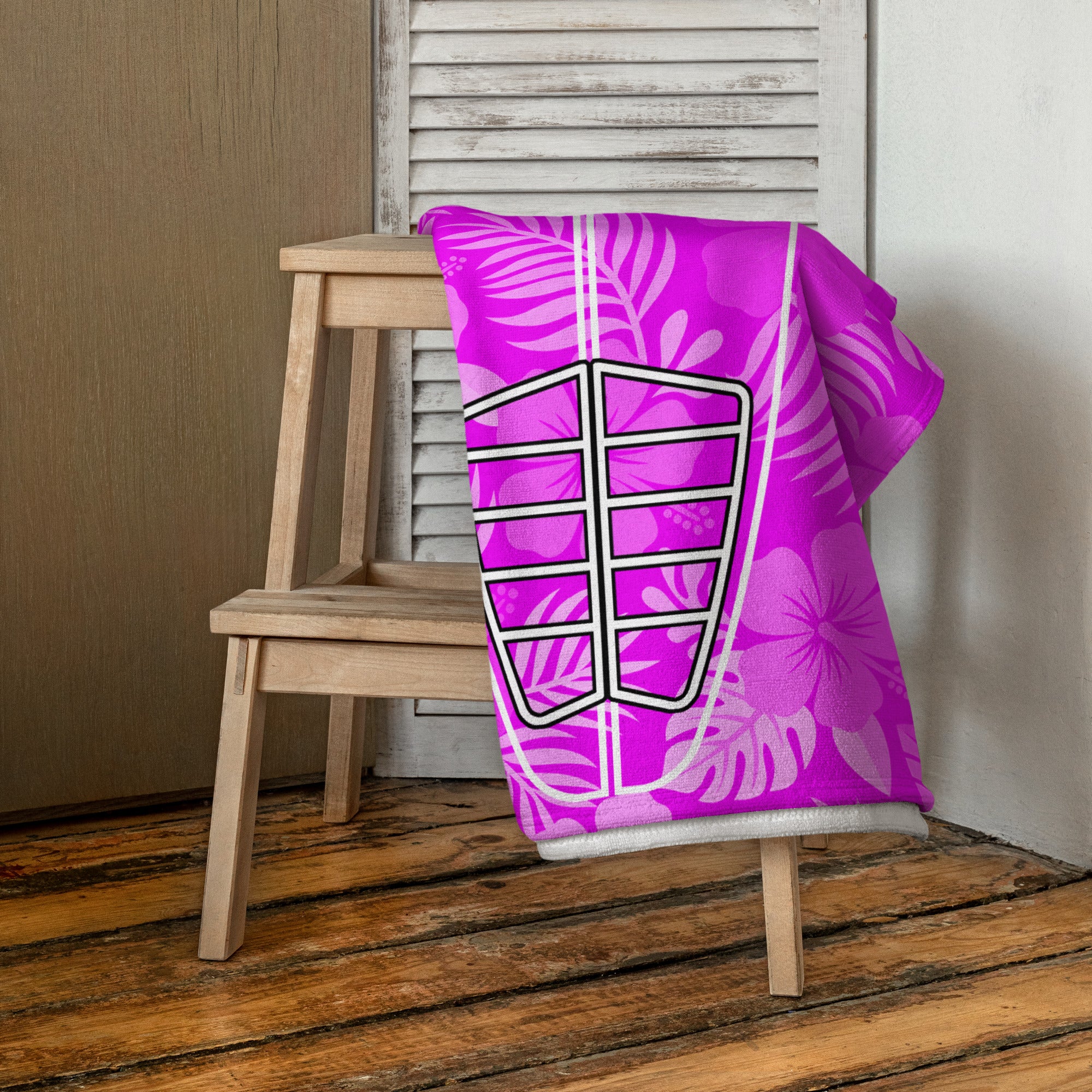 AI generated image of a Pink Hibiscus Surf Pop-Up Training Mat – Oversized Quick-Dry Beach Towel with Stance Placement Guide on chair