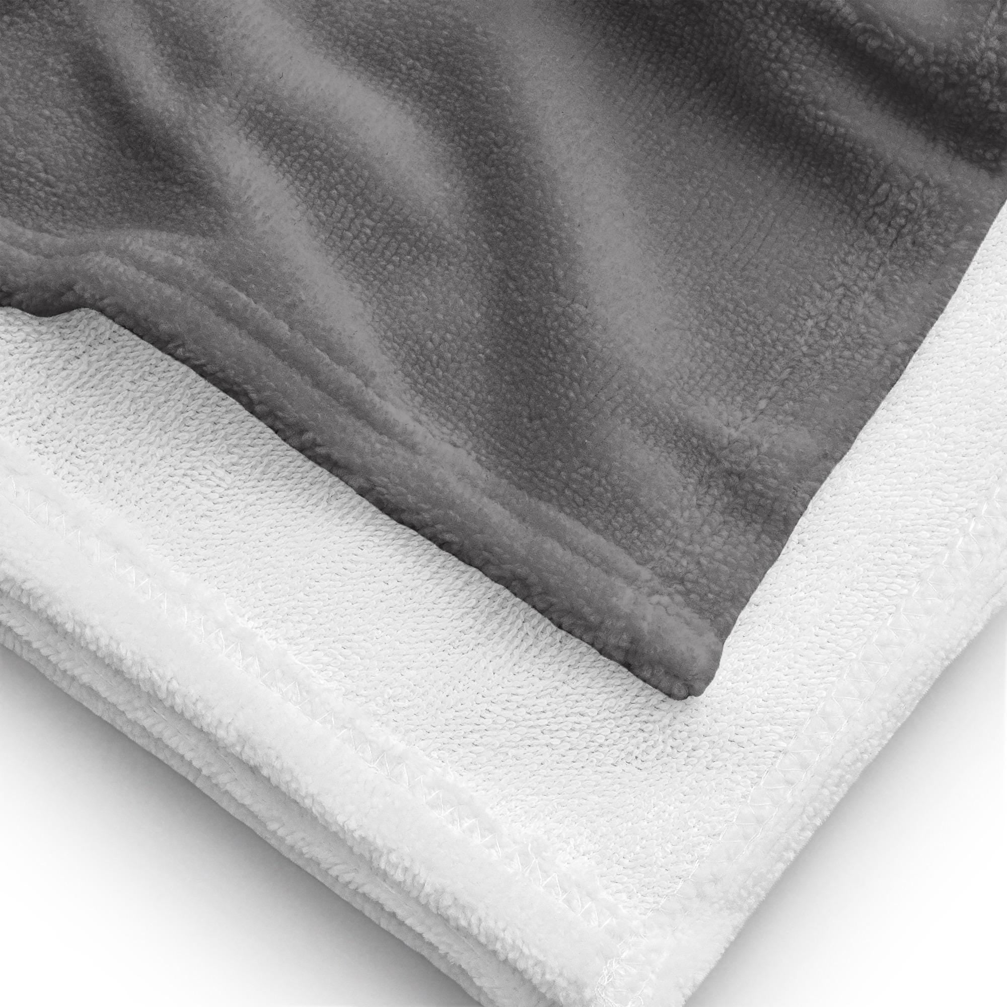 A close-up of a folded Silver Grey Surf Pop-Up Training Mat – Oversized Quick-Dry Beach Towel with Stance Placement Guide on side and a white terry cloth border.